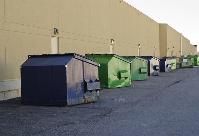 a collection of bright and vibrant dumpsters in a construction zone in Grayslake